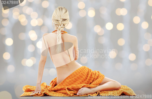 Image of beautiful young woman with orange towel