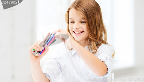 Image of smiling girl choosing colorful felt-tip pen