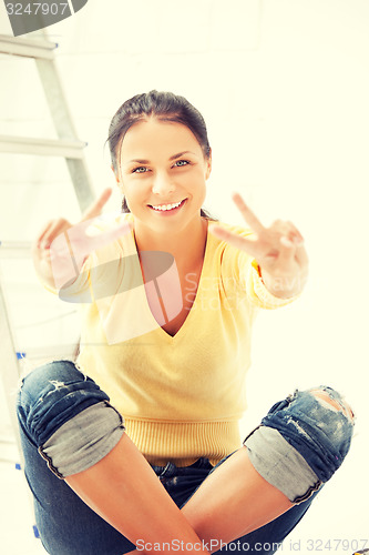 Image of lovely housewife making repairing works