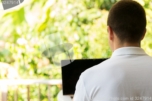 Image of close up of businessman with laptop outdoors