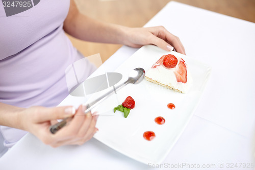 Image of close up of woman eating dessert at restaurant