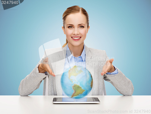 Image of business woman with tablet pc and globe hologram