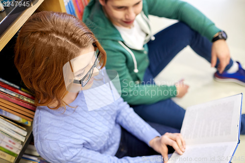 Image of close up of happy students reading book in library