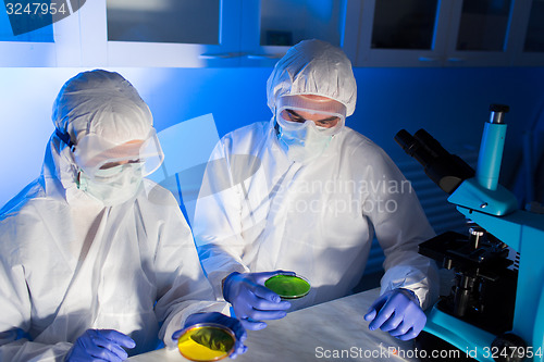 Image of close up of scientists with test samples in lab