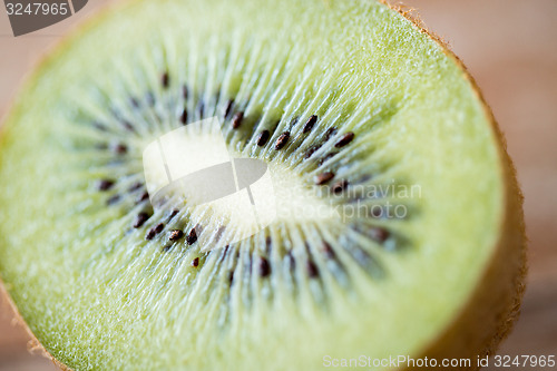 Image of close up of ripe kiwi slice on table