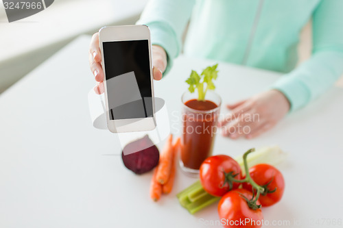 Image of close up of woman with smartphone and vegetables
