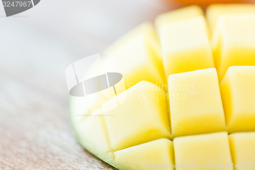 Image of close up of ripe mango slice on table