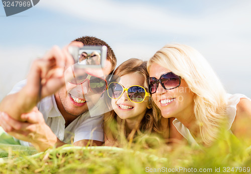 Image of happy family with camera taking picture