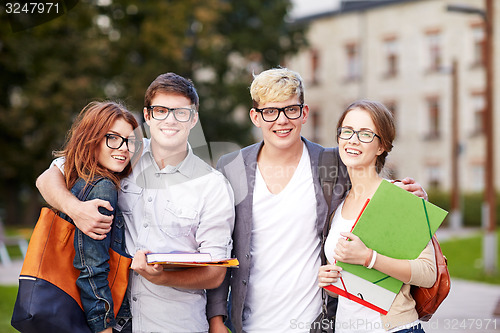 Image of happy teenage students with school folders