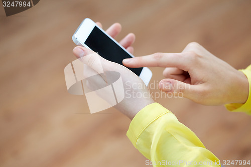 Image of close up of female hands with smartphone at home