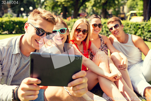 Image of smiling friends with tablet pc making selfie