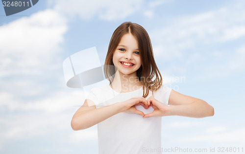 Image of smiling little girl in white blank t-shirt