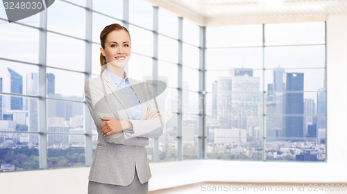 Image of smiling businesswoman with crossed arms