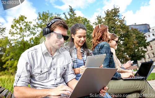 Image of students or teenagers with laptop computers