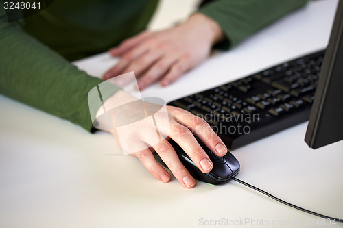 Image of close up of male hands holding computer mouse