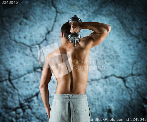 Image of young man with dumbbell flexing biceps