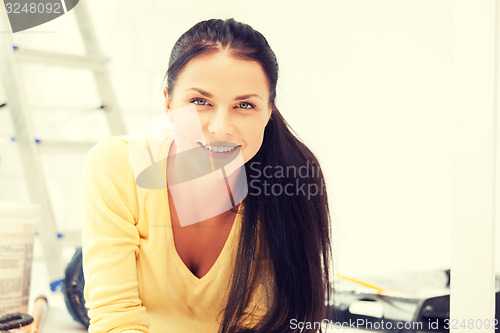 Image of lovely housewife making repairing works