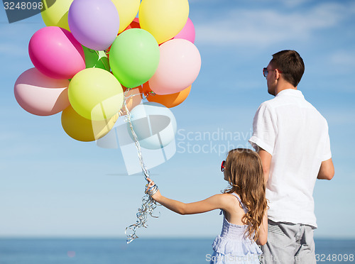 Image of father and daughter with colorful balloons