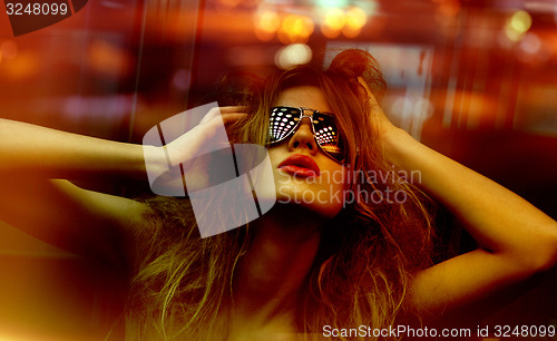 Image of fashionable woman in nightclub