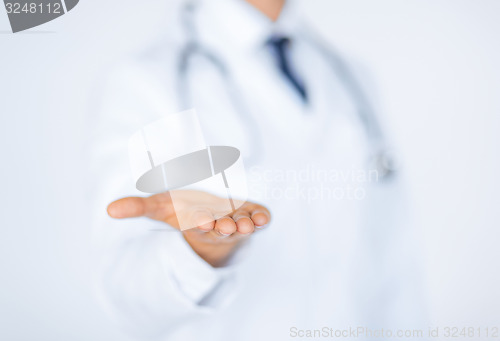 Image of male doctor holding something in his hand