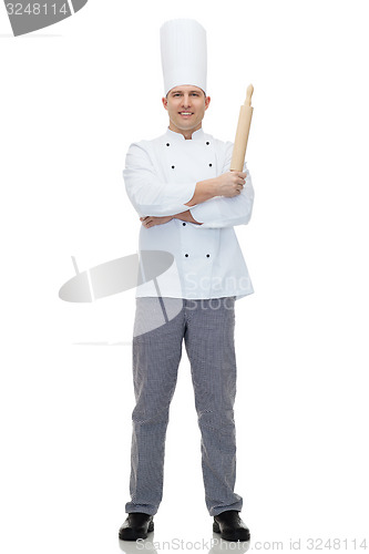 Image of happy male chef cook holding rolling pin