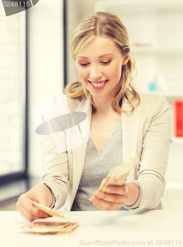 Image of businesswoman with euro cash money