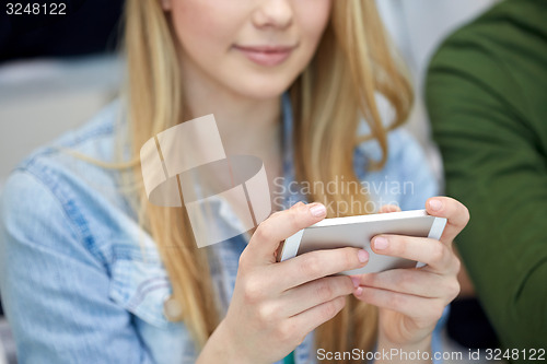 Image of close up of female hands with smartphone