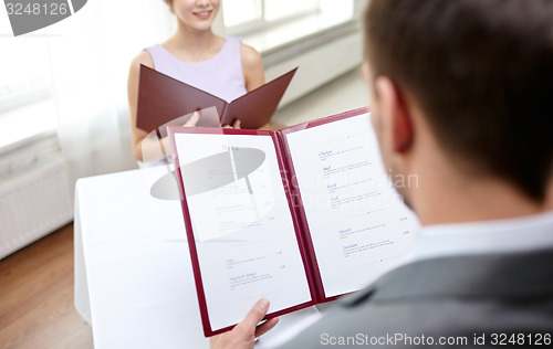 Image of close up of couple with menu at restaurant