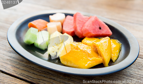 Image of plate of fresh juicy fruits at asian restaurant
