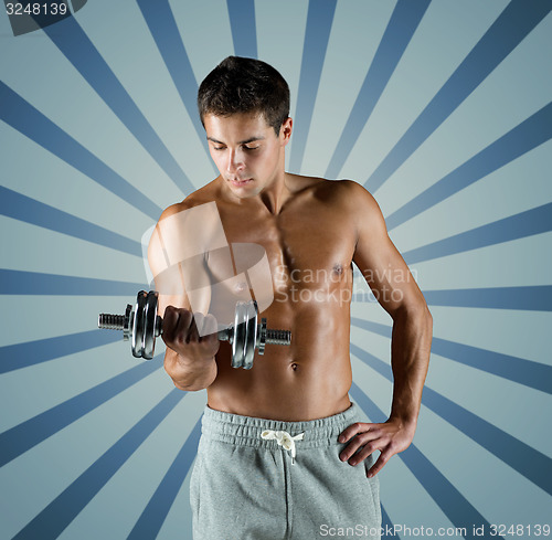 Image of young man with dumbbell flexing biceps