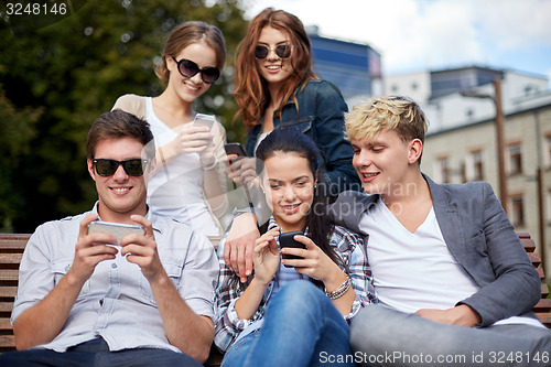 Image of students or teenagers with smartphones at campus