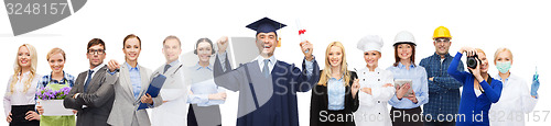 Image of happy bachelor with diploma over professionals