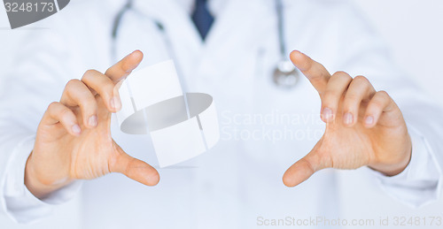 Image of doctor with holding something with hands