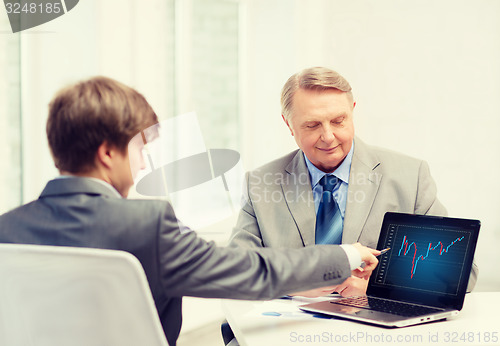 Image of older man and young man with laptop computer