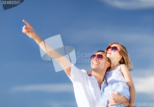 Image of happy father and child in sunglasses over blue sky