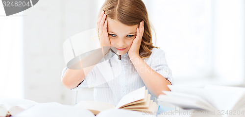 Image of pretty girl with many books at school