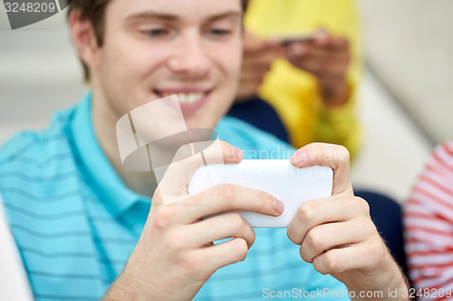 Image of close up of young man with smartphone