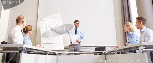 Image of group of smiling businesspeople meeting in office