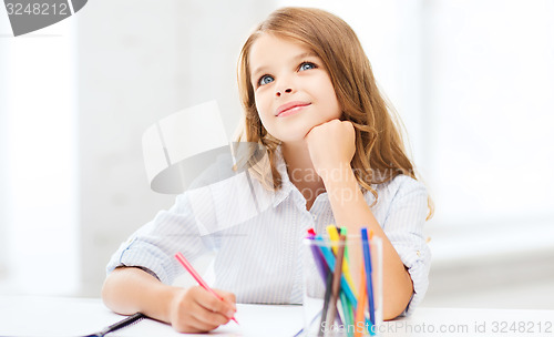 Image of little student girl drawing at school