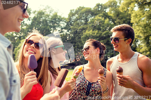 Image of group of smiling friends with ice cream outdoors