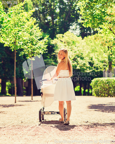 Image of happy mother with stroller in park