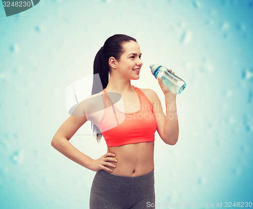 Image of sporty woman with water bottle