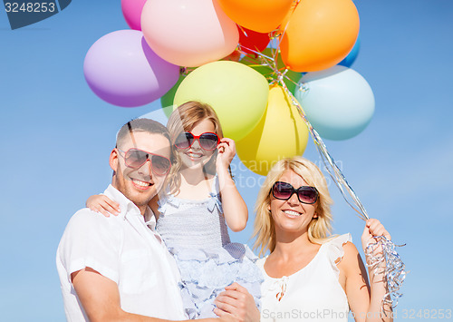 Image of family with colorful balloons