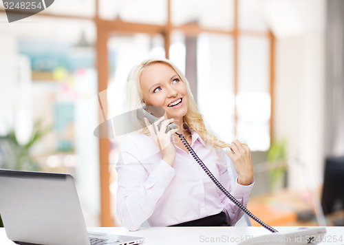 Image of smiling businesswoman or student calling on phone