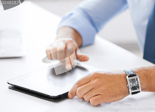 Image of businessman with tablet pc in office