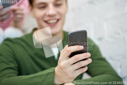 Image of close up of young man with smartphone