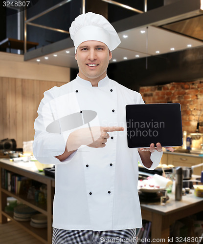 Image of happy male chef cook showing with tablet pc