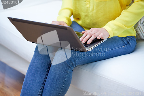 Image of close up of woman with laptop computer at home