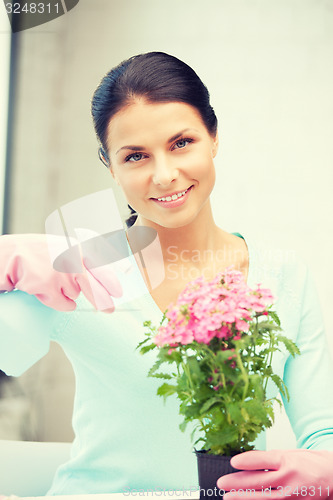 Image of lovely housewife with flower