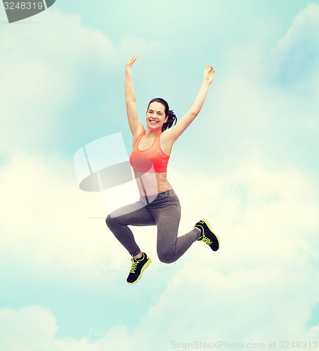 Image of sporty teenage girl jumping in sportswear